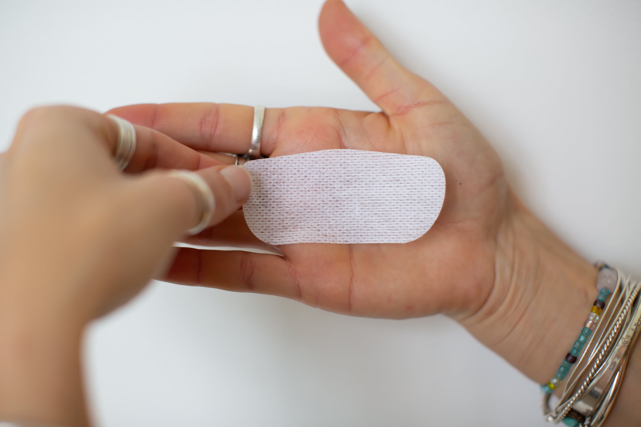 model holding flat a single strip of oi tape non-vented mouth tape